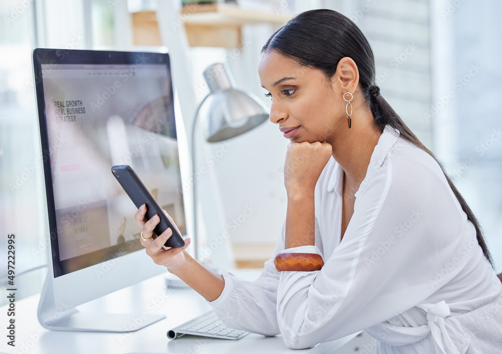 Designed to keep me discreetly, neatly in the corner. Shot of a young businesswoman scrolling on her cellphone in a modern office. Designed to keep me discreetly, neatly in the corner. Shot of a young businesswoman scrolling on her cellphone in a modern office.