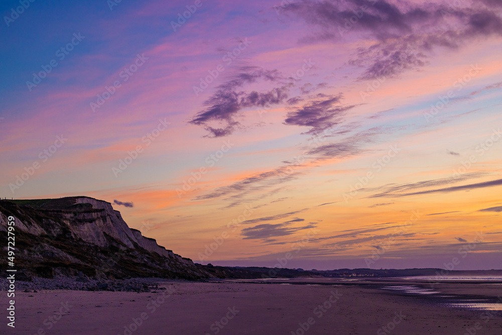 Sunrise over the beach with dramatic colorful clouds, waves and cliffs, Cap Blanc-Nez. High quality photo Sunrise over the beach with dramatic colorful clouds, waves and cliffs, Cap Blanc-Nez. High quality photo
