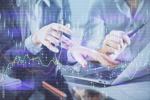 Multi exposure of man and woman working together and financial chart hologram. Business concept. Computer background.