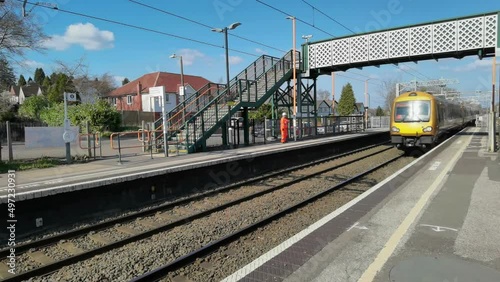electric train passing through station england uk
