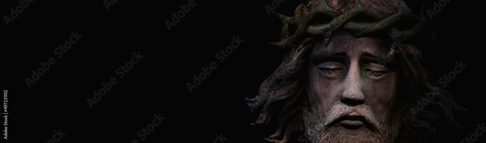 Dramatic image of Jesus Christ in a crown of thorns. Fragment of an ancient statue. Copy space for text. Dramatic image of Jesus Christ in a crown of thorns. Fragment of an ancient statue. Copy space for text.