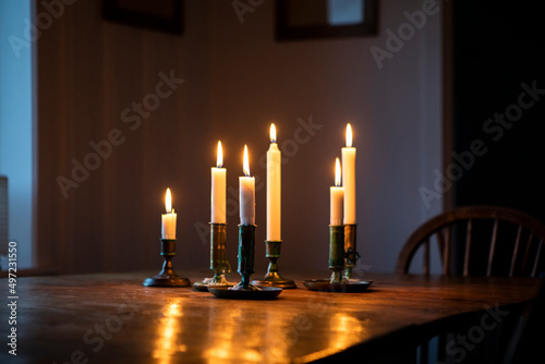 Lit candles on wooden table