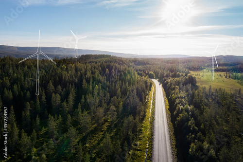 Wind turbines models in green landscape photo