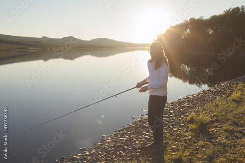 Person fishing at river