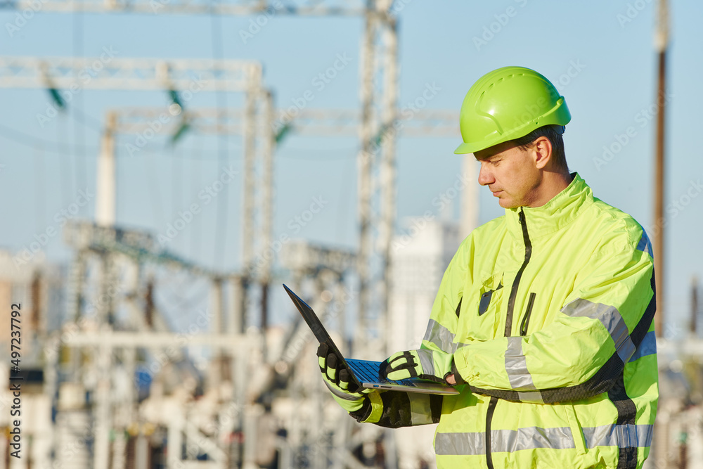 Service engineer working with laptop at heat electric power station