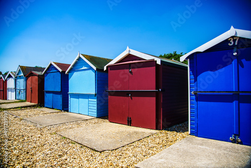 Red beach hut among Blue beach huts