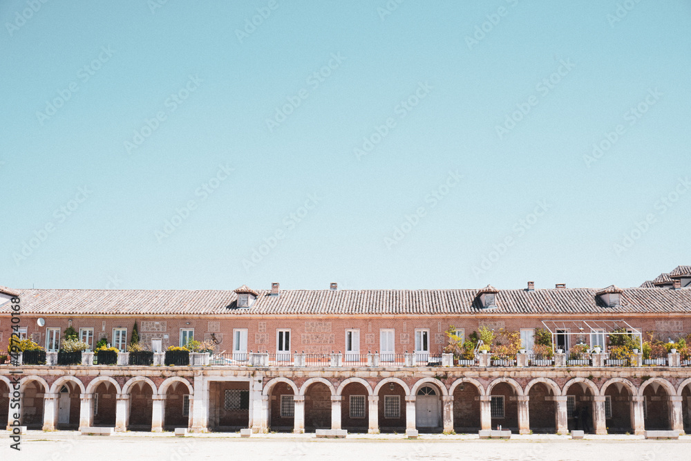 Archs on the Royal Palace surroundings in Aranjuez, Madrid, Spain. Ancient royal court building. Currently houses with terrace. Aesthetic