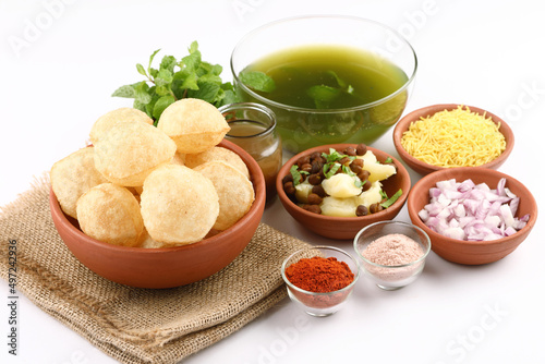 Panipuri or Golgappa is a popular street snack from India. It's a round, hollow puri filled with a mixture of flavoured water and other chat items photo