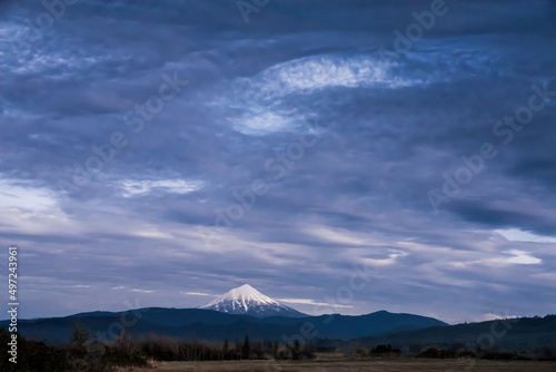 Beautiful scene of Mount McLoughlin old volcano in Oregon with large purple cloudy sky in USA photo