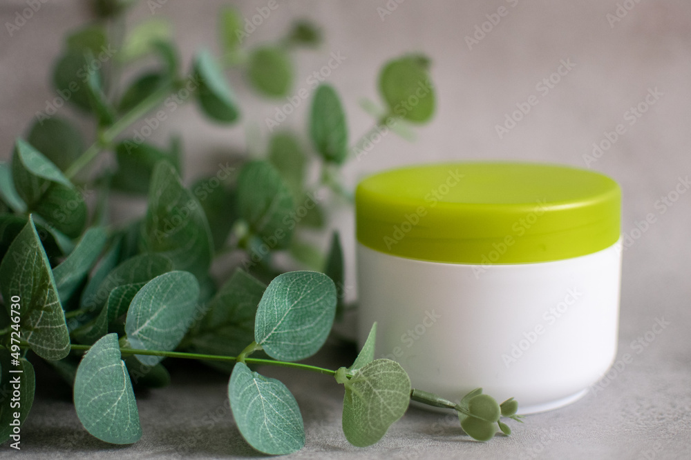 Bottle of body cream. Cosmetic and beauty product. Background with green plants. Bottle of body cream. Cosmetic and beauty product. Background with green plants.