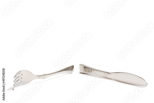 Knife and fork stacked up isolated on white background. Side View.	