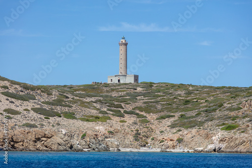 Lighthouse, stone and concrete beacon on hill at Ermoupolis port, Syros island, Greece. photo