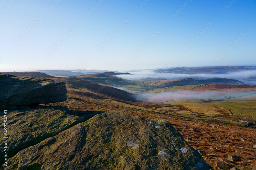 Fototapeta premium Down the mist filled valleys of Derbyshire from high on Stanage Edge
