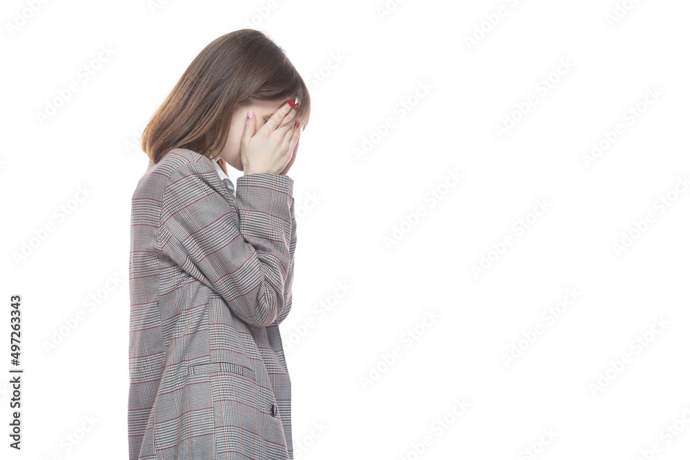 Portrait of a young woman in a jacket holding her hands near her face. Crying, tears, years. Isolated on white background. Portrait of a young woman in a jacket holding her hands near her face. Crying, tears, years. Isolated on white background.