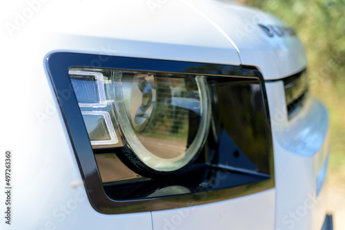 Headlight of modern prestigious car close up © rostovdriver