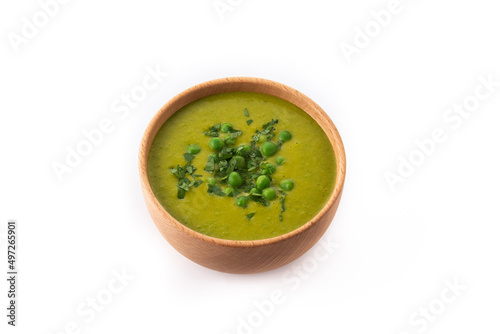 Green pea soup in a bowl isolated on white background