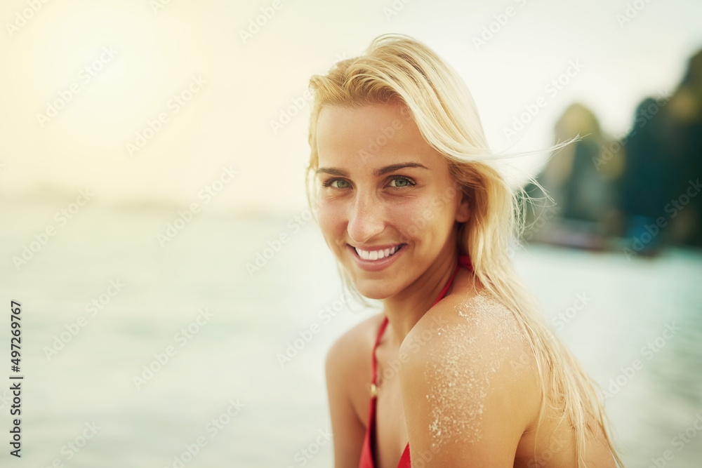 I love everything about the beach. Shot of a young woman spending the day at the beach. I love everything about the beach. Shot of a young woman spending the day at the beach.