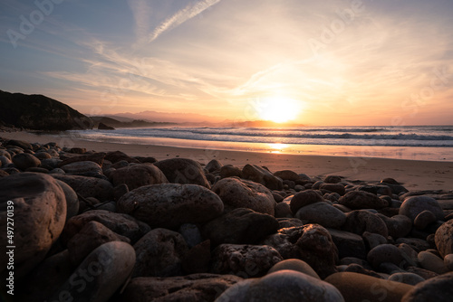 Rocky beach with round stones during sunset