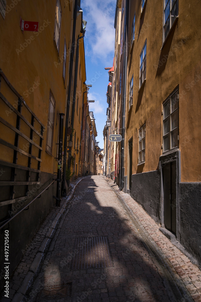 Narrow street view in the old town Gamla Stan a sunny spring day in Stockholm