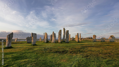 Callanish standing stones against blue cloudy sky at sunrise in Isle of Lewis, Scotland photo