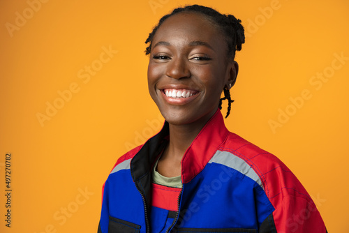 Young african american handywoman in yellow studio