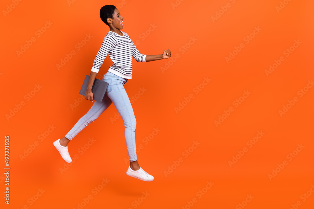 Full length body size view of attractive cheerful girl jumping going copy space isolated over shine orange color background