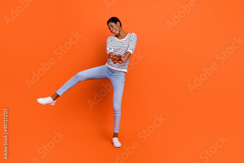 Papier peint Photo of funky pretty butch lady dressed sweater rising dancing smiling isolated
