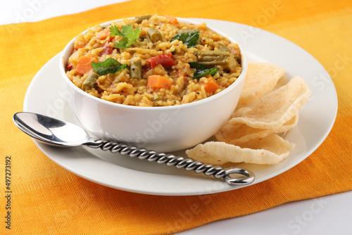 Sambar Rice - Tasty and popular south indian recipe served in a ceramic bowl with appalam or papad