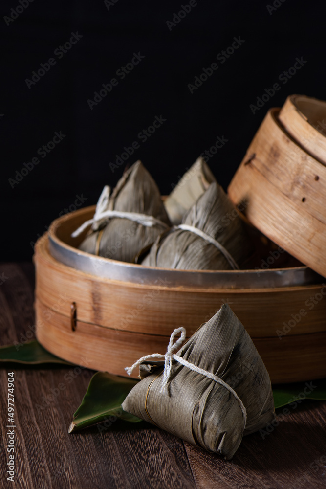 Zongzi. Rice dumpling for Dragon Boat Festival on dark wooden table background.
