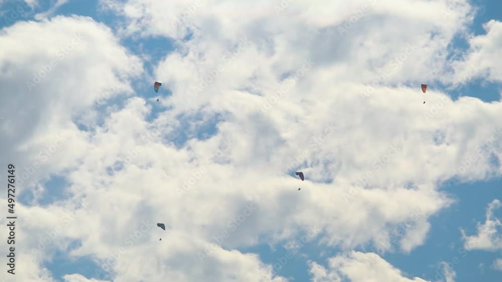 Parachutes in front of the clouds at Manali in Himachal Pradesh, India. Tourists enjoying paragliding experience at Manali. People enjoying the paragliding experience at Manali Parachutes in front of the clouds at Manali in Himachal Pradesh, India. Tourists enjoying paragliding experience at Manali. People enjoying the paragliding experience at Manali