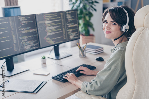 Profile side view portrait of attractive cheery girl expert specialist coding html task talking client at work place station indoors