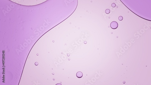 Purple oil being poured in transparent liquid floating on it's surface against violet background | Background for skincare cosmetics