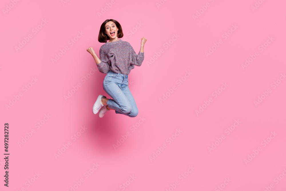 Full length body size view of attractive cheerful girl jumping rejoicing having fun isolated over pink pastel color background Full length body size view of attractive cheerful girl jumping rejoicing having fun isolated over pink pastel color background