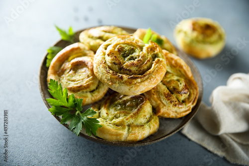 Homemade puff pastry swirls with pesto sauce