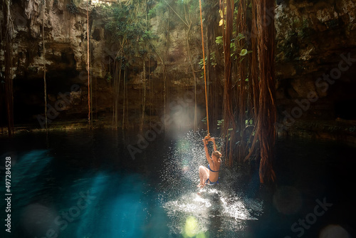  Girl on a bungee. Cenote Ik-Kil Yucatan. Mexico. photo