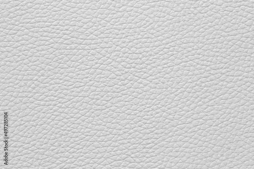 Close-up of a white leather and textured background.