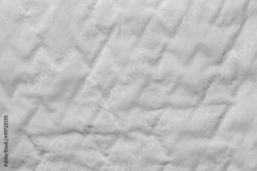 Close up of a white cotton incontinence pad texture background.