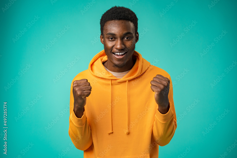 Portrait of overjoyed black man celebrating success in studio Portrait of overjoyed black man celebrating success in studio