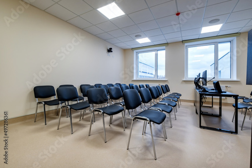  rows of seats in interior of modern empty conference hall for business meetings