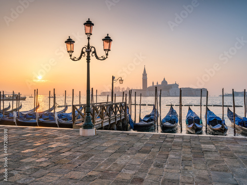 Gondolas on the Bacino di San Marco at sunrise with view of island San Giorgio Maggiore in the background, Venice, Italy photo