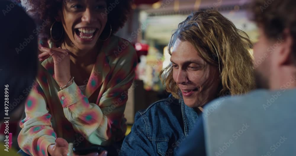 Cinematic close up shot of group of young happy multiracial college friends enjoying drinks and having fun to use smart phone at table after playing bowling together on weekend in sporting club. Cinematic close up shot of group of young happy multiracial college friends enjoying drinks and having fun to use smart phone at table after playing bowling together on weekend in sporting club.