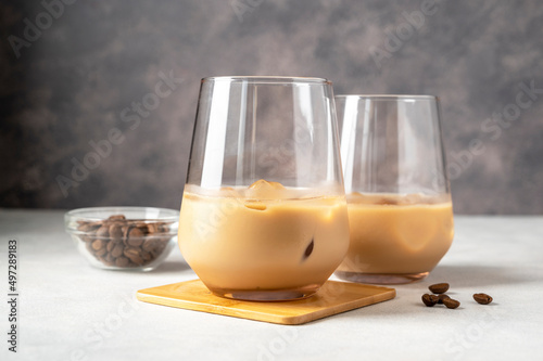 Irish cream liqueur in a glass with ice cubes and coffee beans photo