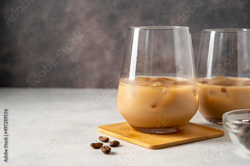 Billede på lærred Irish cream liqueur in two glasses with ice cubes and coffee beans, copy space f
