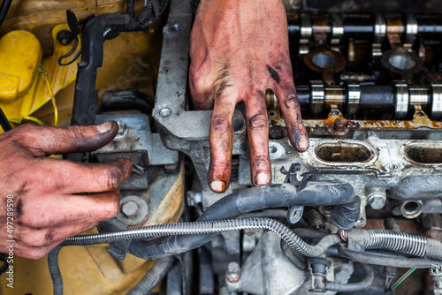 Man Mechanic Hands Repairing a Car Engine