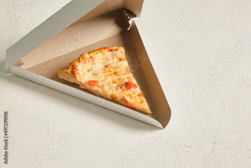 a piece of pizza in a takeaway carton box