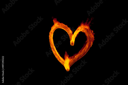 Single burning heart shape on black background