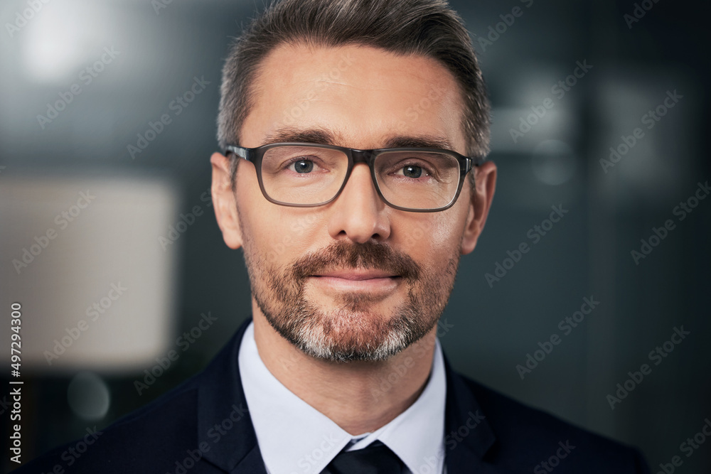 Success isnt something you get, you earn it. Portrait of a mature businessman standing in his office. Success isnt something you get, you earn it. Portrait of a mature businessman standing in his office.