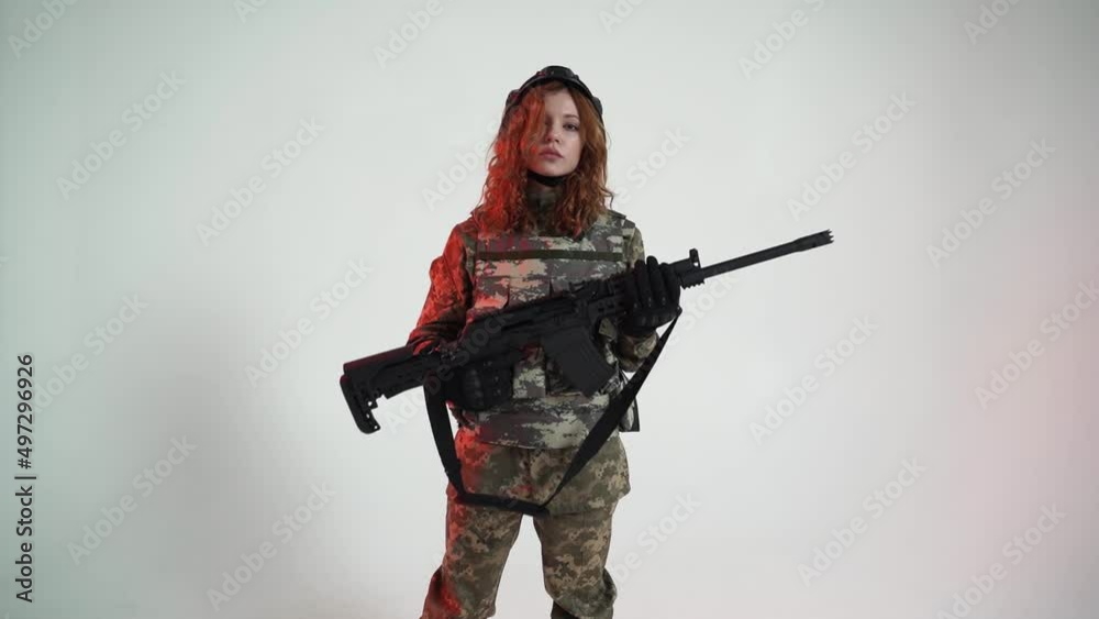 Ukrainian woman posing at the camera with an assault rifle Concept of war in Ukraine Ukrainian woman posing at the camera with an assault rifle Concept of war in Ukraine