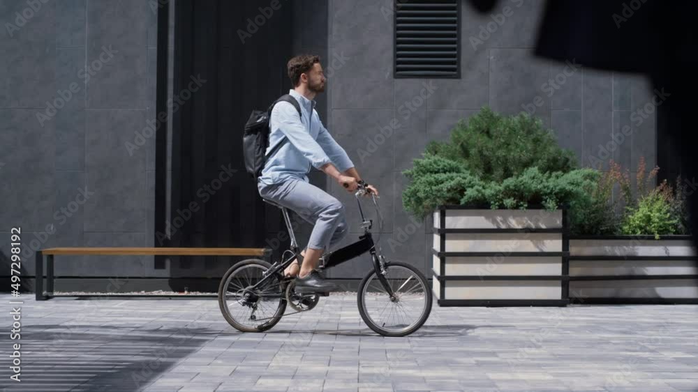 Attractive manager commuting to office on bicycle sunny morning. City transport Attractive manager commuting to office on bicycle sunny morning. City transport