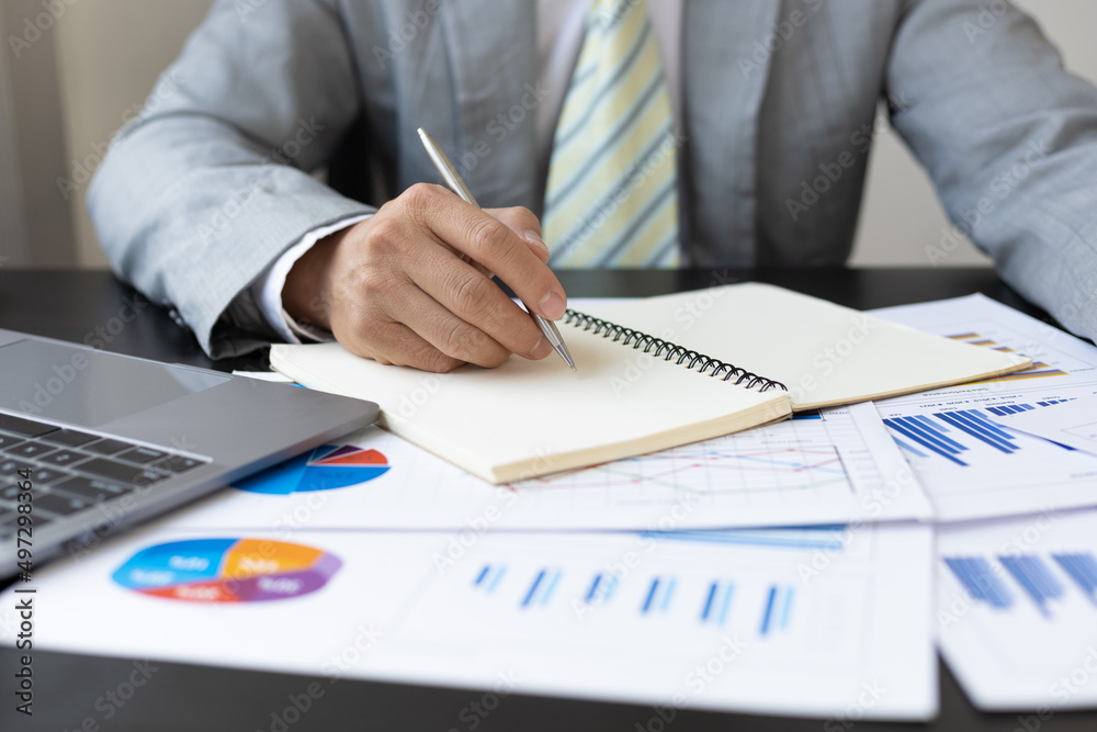 Accountant man writing a note for make financial report or company's profit annual at desk, bookkeeper job. Accountant man writing a note for make financial report or company's profit annual at desk, bookkeeper job.